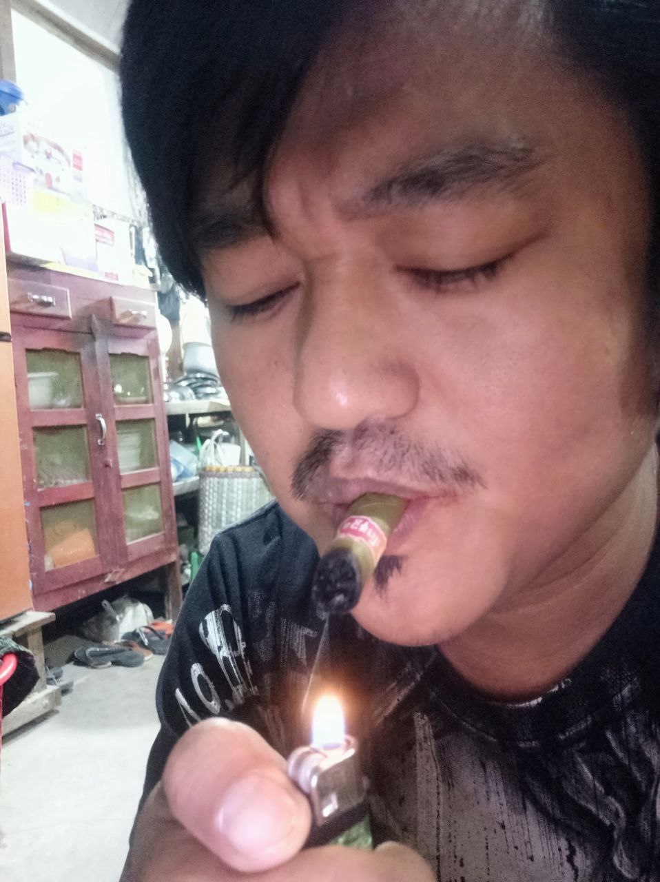 a person lighting a cigarette